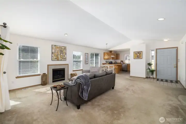 Light and bright great room with vaulted ceiling, natural gas fireplace.