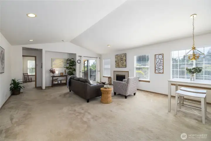 Great room has slider to the back deck and fenced back yard.  Guest bedroom wing is through the doorways at left.