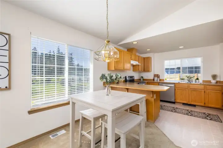 Spacious kitchen has breakfast bar, plenty of storage, and a pantry.