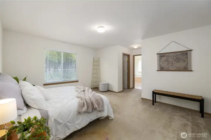The primary suite with private en-suite and TWO walk-in closets.