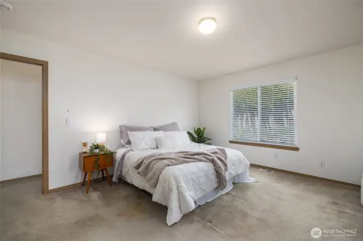 The primary suite is located away from the guest bedrooms and has plenty of room for a seating area.
