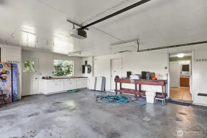 Attached two car 650sf oversized garage with work benches and separate utility room with bence and sink.Entry into the laundry room with 3/4 bath. Attached two car 650sf oversized garage with work benches and separate utility room with bence and sink.Entry into the laundry room with 3/4 bath.