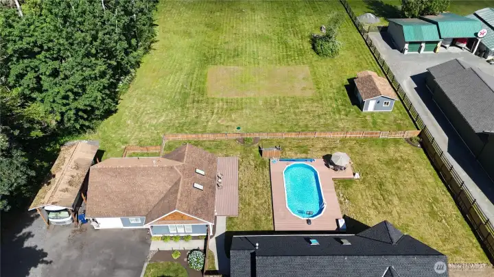 Looking at the pool, shop to your right with a covered area for the riding mower Looking at the pool, shop to your right with a covered area for the riding mower