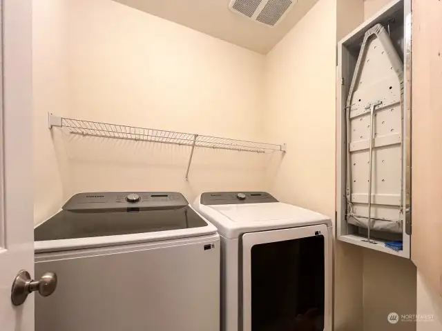 Laundry room with ironing board