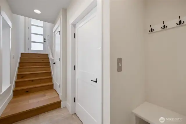 Gorgeous hardwood flooring on stairs. Door to elevator on the right.
