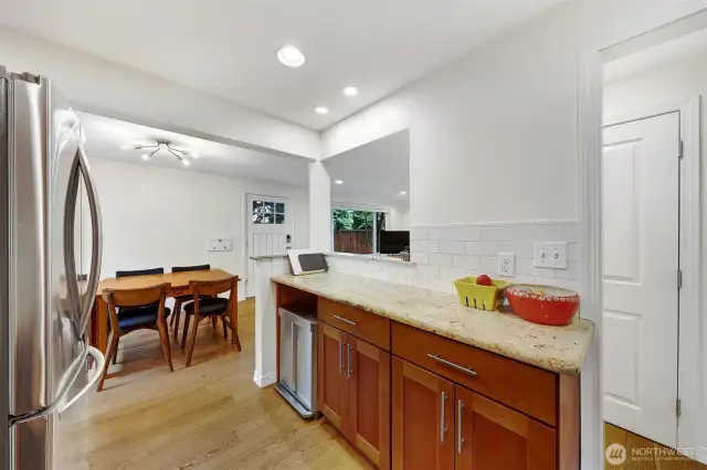 Kitchen to separate dining area. Looking toward front door.