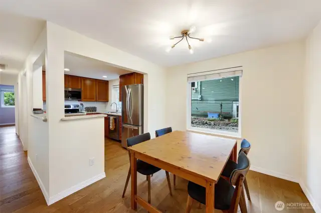 Dining area toward kitchen and hall to bedrooms on left.