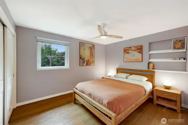 Main bedroom at back side of house. Ceiling fan complements the A/C.