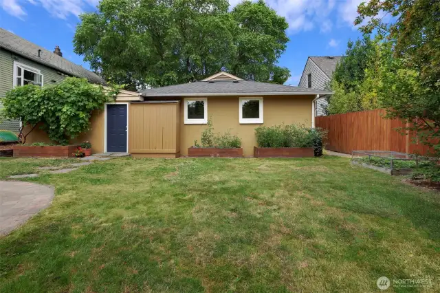 Note raised garden beds. So much room and light in backyard to grow to one's delight.