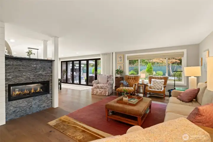 Open living with double sided fireplace.