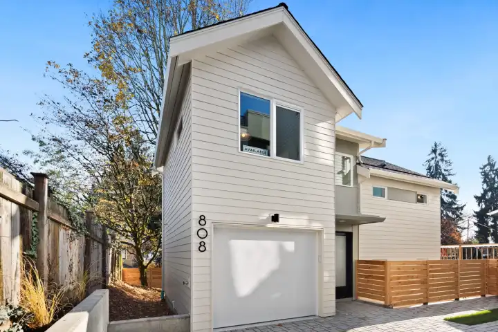 808 is a cottage with garage. The unique floor plan has a sunken living/dining/kitchen and each bedroom is on its own level.