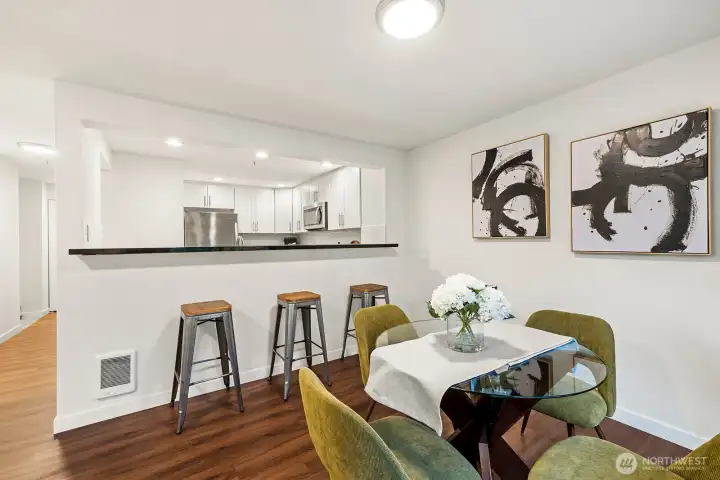 Spacious dining area with eat-in bar to kitchen