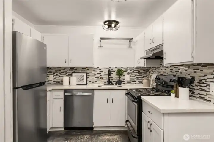 New stainless refrigerator and dishwasher, quartz counter tops, designer back splash tiles. Contemporary under-mount sink, and updated lighting makes this Kitchen the one you want to spend time in.