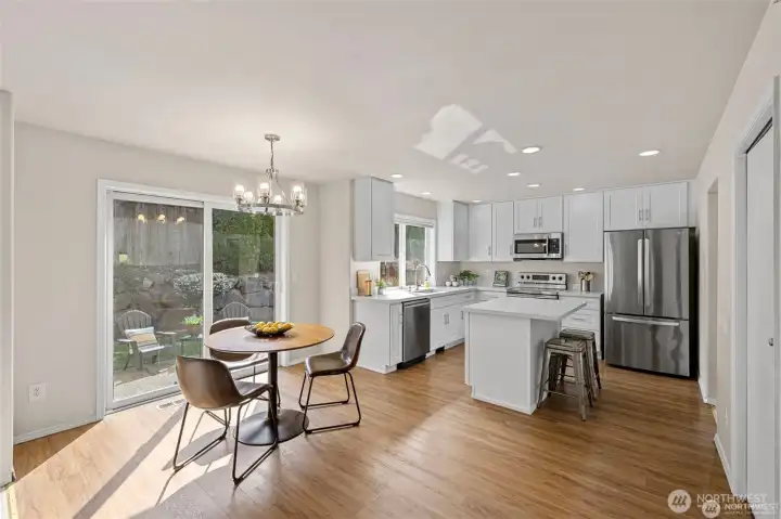 Experience the ultimate in modern living with an open-concept family room and kitchen designed for connection. Bathed in bright, natural light, this expansive space feels both grand and incredibly welcoming.  ?The brand-new kitchen—boasting modern finishes and a functional layout—flows effortlessly into the cozy family room, making it the perfect hub for daily life or weekend entertaining. At the center of it all, a warm gas fireplace serves as a stunning focal point, offering the perfect glow for chilly PNW evenings. Whether you're prepping a meal or relaxing on the sofa, this sun-drenched sanctuary is where your best memories will be made.