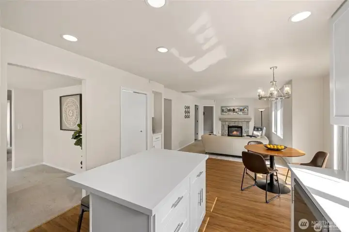 Experience the ultimate in modern living with an open-concept family room and kitchen designed for connection. Bathed in bright, natural light, this expansive space feels both grand and incredibly welcoming.  ?The brand-new kitchen—boasting modern finishes and a functional layout—flows effortlessly into the cozy family room, making it the perfect hub for daily life or weekend entertaining. At the center of it all, a warm gas fireplace serves as a stunning focal point, offering the perfect glow for chilly PNW evenings. Whether you're prepping a meal or relaxing on the sofa, this sun-drenched sanctuary is where your best memories will be made.