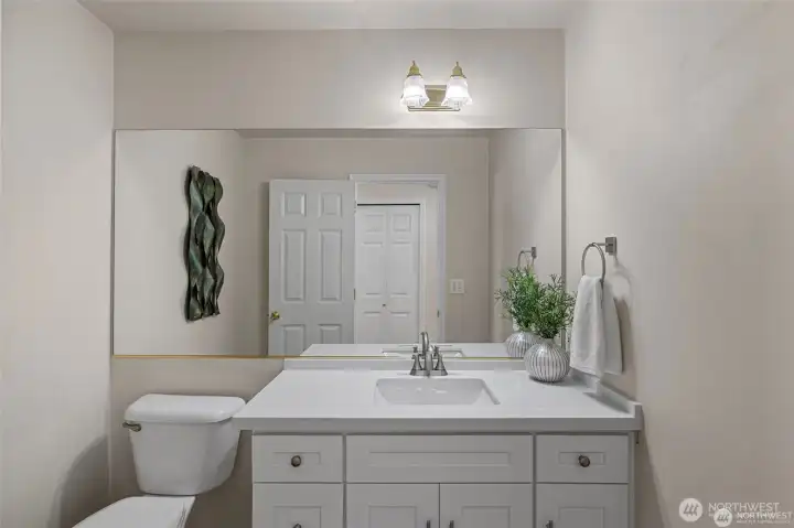 Sophisticated Main-Floor Essentials  ?Conveniently located for guests and daily life alike, the main-floor powder room makes a statement with its sleek, modern style.  ?Every detail has been curated to reflect a contemporary aesthetic, offering a polished and high-end feel that complements the home’s overall design. It’s a small space that delivers a big impact, ensuring that even the most functional rooms in the house feel stylish and intentionally crafted.