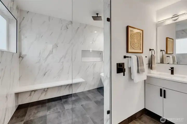Primary bedroom’s bath with large walk-in shower and tub.
