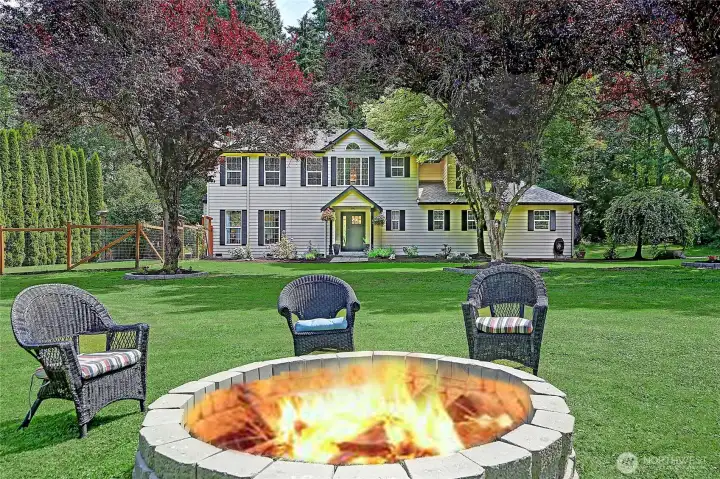 Enjoy the spacious backyard complete with a welcoming fire pit, offering the ideal setting for entertaining guests, making memories with family and friends, or simply unwinding beneath the stars.