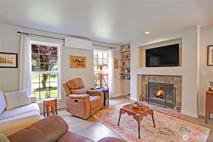 Enjoy cozy evenings by the fireplace in this comfortable family room, a perfect place to gather, entertain, or simply unwind after a long day.