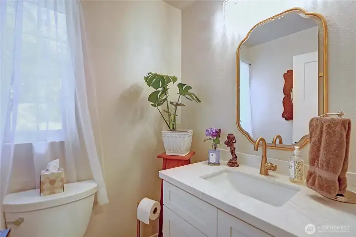Stylish main-level powder room thoughtfully designed for guests and daily convenience.