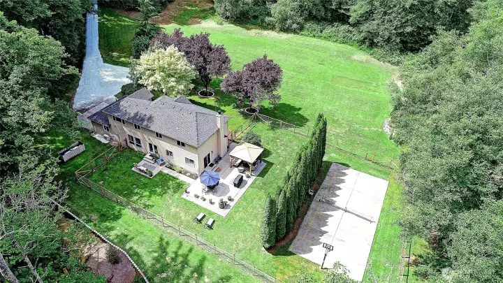 Aerial view highlighting the home's beautiful setting and impressive grounds.
