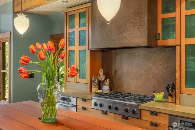 The kitchen showcases a custom copper cook-top hood, personally designed by Bernie.