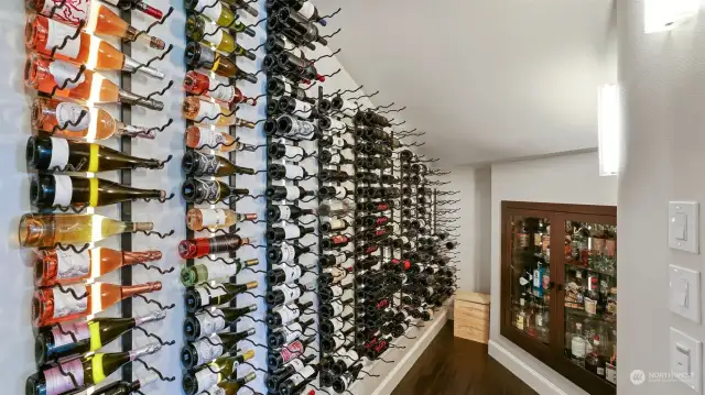 Climate controlled 550 bottle wine cellar includes walnut-lined liquor cabinet insert.