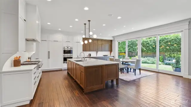 Gorgeous kitchen remodel features Rift-cut white oak cabinetry, high-end appliances including dual Miele dishwashers, Sub Zero refrigerator and freezer and Wolf double ovens and cooktop.