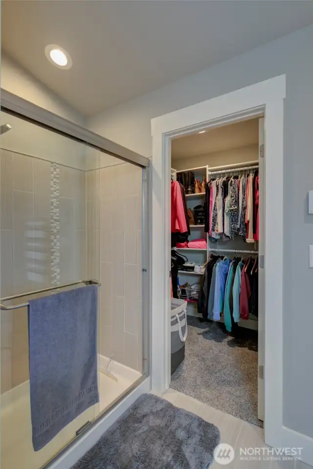 Just beyond the tub is the step-in shower and walk in closet.
