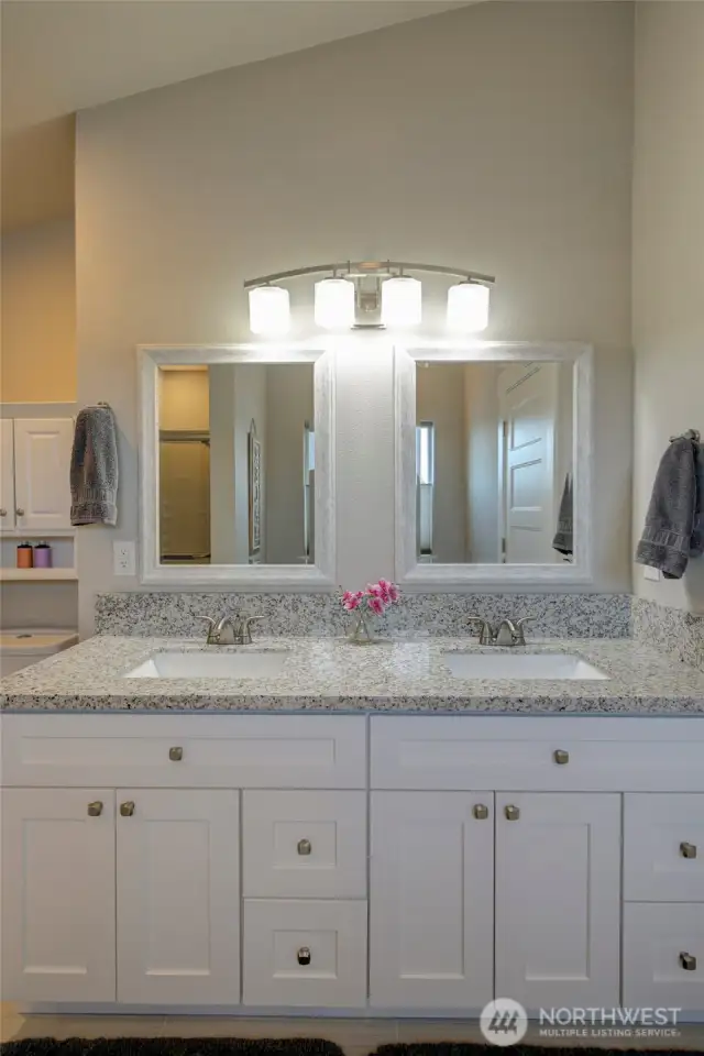 The toilet and large dual vanity round out the primary bath.