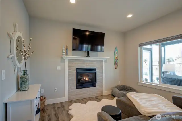 Open concept living/dining/kitchen with access to the sunroom and sweeping water views.