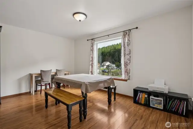 With enough room for a sizable dining table and hutch, this wood laminate floor dining space still leaves room for life beyond dinner. Whether it’s carving out a homework nook, a home office, or just a cozy corner to sip your morning coffee, the flexibility is built right in.
