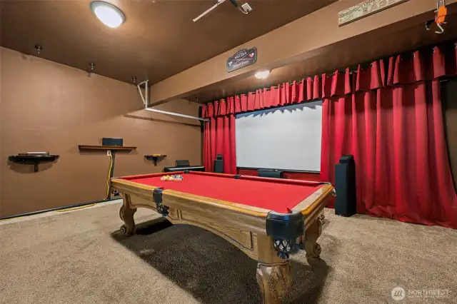 This entertainment room’s got the mood on point. Painted in a rich, chocolate brown, it’s the perfect backdrop for movie nights and pool matches. And yes, the pool table even has red velvet to match the curtains, details matter, folks!