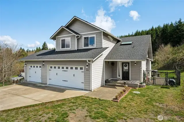 The front of this home is designed for both beauty and practicality. Carriage-style garage doors (two-car and single) create instant curb appeal. The wide driveway offers plenty of space for your vehicles, and the spacious front walkway leads you to the perfect covered porch for relaxing.