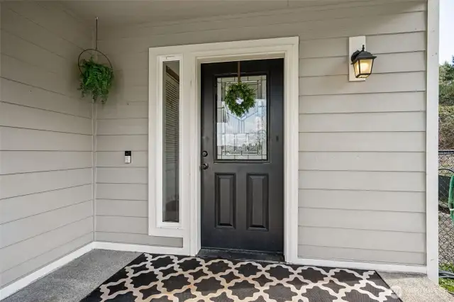 First impressions matter, and this front porch nails it. With a sleek black front door, tan paint, and crisp white trim, it’s the perfect mix of modern charm. The large covered space is ideal for seating, holiday displays, or potted plants, basically, it’s ready to welcome whatever you’ve got planned.