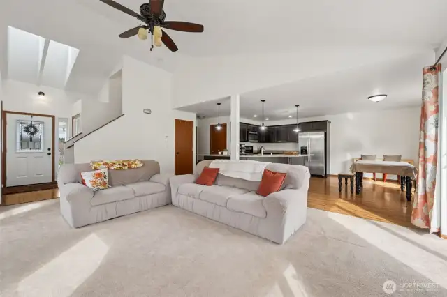 This layout knows how to work a room. From the living area, you’ve got a seamless view of the entry, complete with skylights bringing in that mood-boosting daylight, and a stylish transition to wood floors that subtly says, “we actually care about design.” It’s open, it’s intentional, and it’s quietly fabulous.