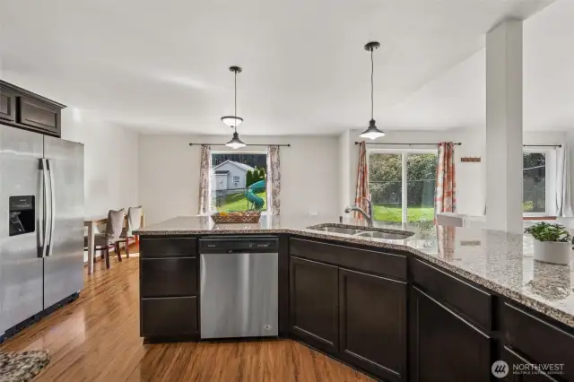 From the kitchen, you get the best of both worlds, tons of storage and the serene view through the dining and living room windows, plus a sliding glass door leading outside. The undermount sink in the peninsula and the dishwasher make cleanup a breeze, keeping things stylish and functional.