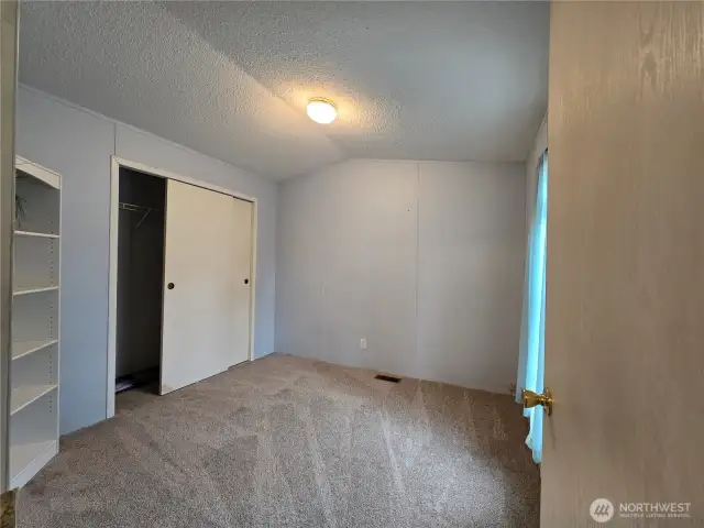 Bedroom 2 w/new carpet. New hot water tank is behind wall in closet.