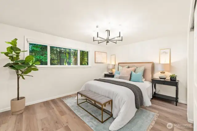 Primary bedroom with picturesque tree lined views of the backyard