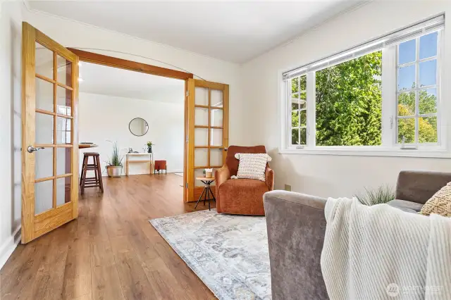 Beautiful flooring flows throughout the home, complemented by French doors.