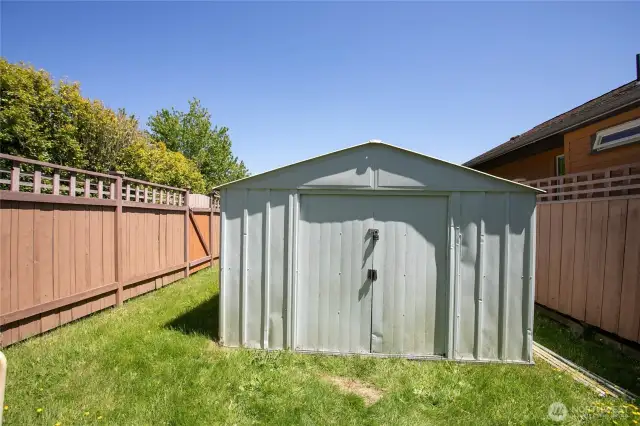 Functional storage shed and a great yard layout offering the option for a dog run.