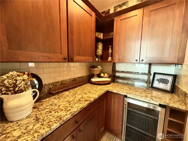 Butler's pantry w/ wine fridge and extra storage.