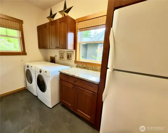 Utility room w/ extra fridge.