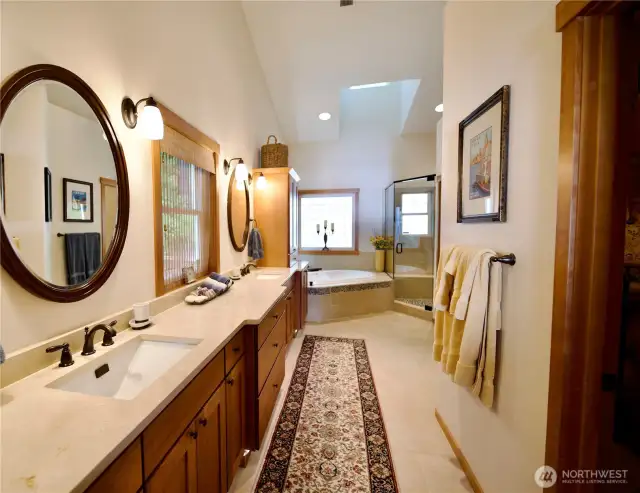 Spa bathroom w/ double vanity and large walk-in closet.