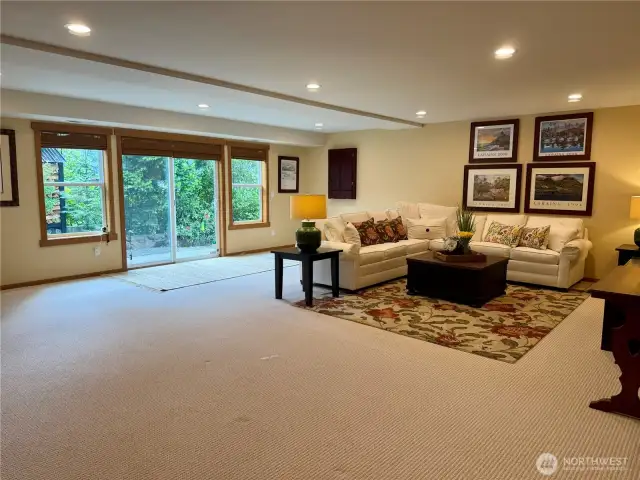 Extra living space in family room downstairs w/ recess lighting and slider leading to lake.