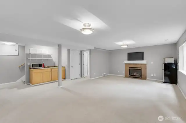 another view of the lower level with fireplace and separate entrance