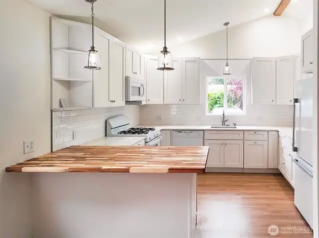 Kitchen with Butcher block and Quartz counters