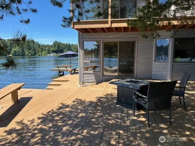 Come live the Northwest lifestyle in this lovely home with expansive decks and its own dock