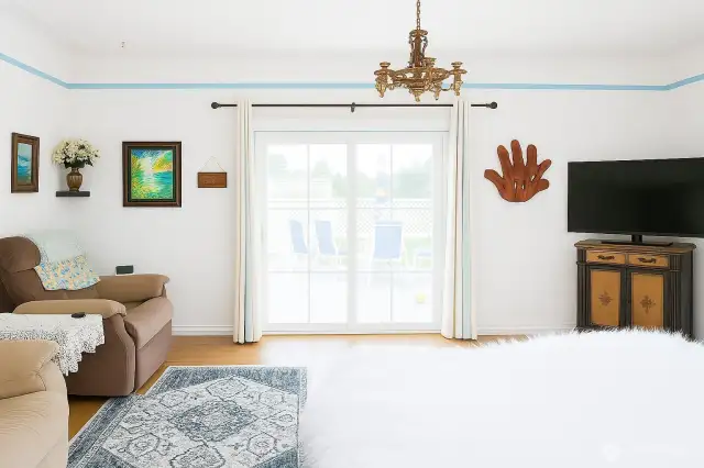 Just off the entry you'll find the bright living room. French doors lead to large deck on side of the house.
