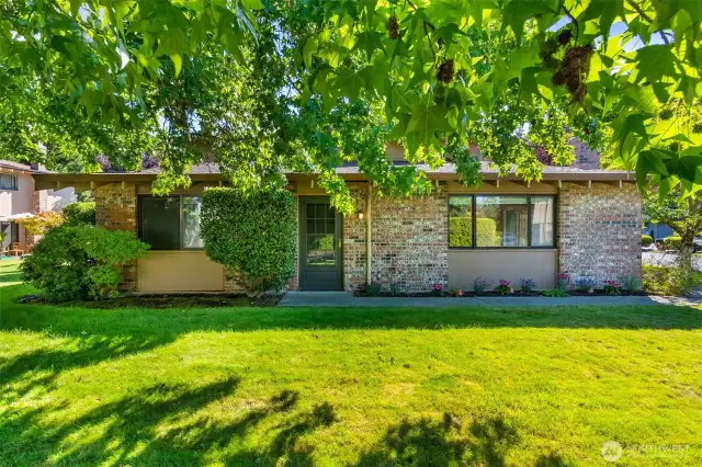 This ground floor, single-level condo is set in a beautiful location and welcomes everyone with a charming brick facade.